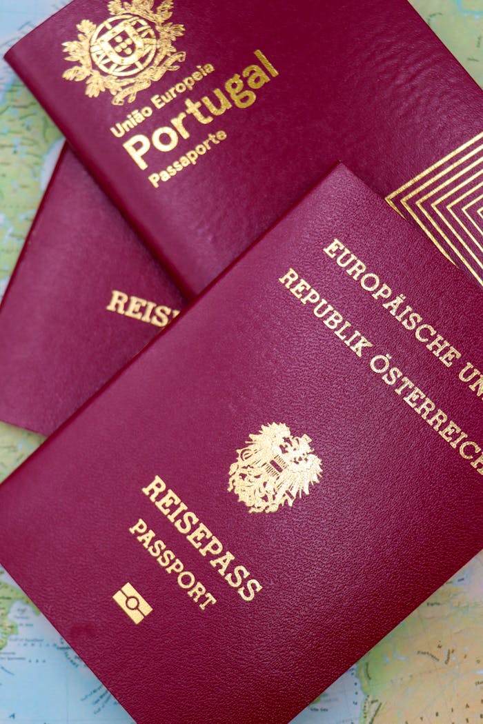 services-04 Close-up of Portugal and Austrian passports on a map, symbolizing travel and European mobility.